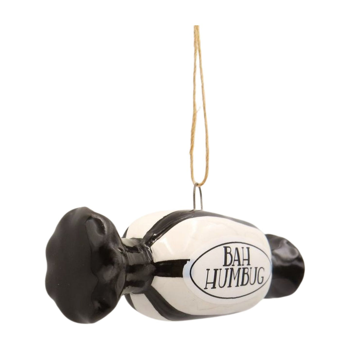 A novelty hanging ornament shaped like a candy, with a black and white body, the words 'BAH HUMBUG' printed on the front, and a tan string for hanging.