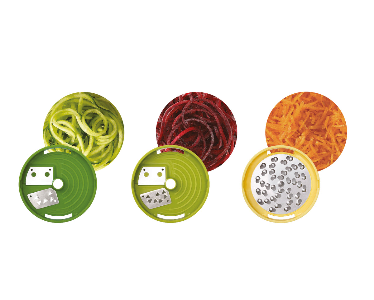 Three circular kitchen accessory pieces shown on a white background, each with a colored outer ring and a metal inner blade section. Above them are three corresponding shredded food results: pale green noodles, dark red beets, and orange cheese.