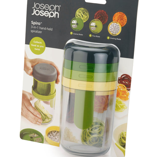 Joseph Joseph Spiro 3-in-1 hand-held spiralizer in its retail packaging, featuring a green and clear plastic body with a dark gray cap.