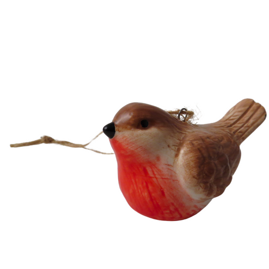 A small bird-shaped ornament or figurine with a brown textured body, bright red chest, cream-colored face, black beak, and a thin hanging string, isolated on a white background.